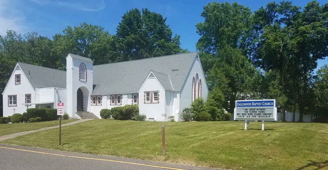 Englewood Baptist Church and its sign: The grass withers, the flower fades, but God's word stands forever